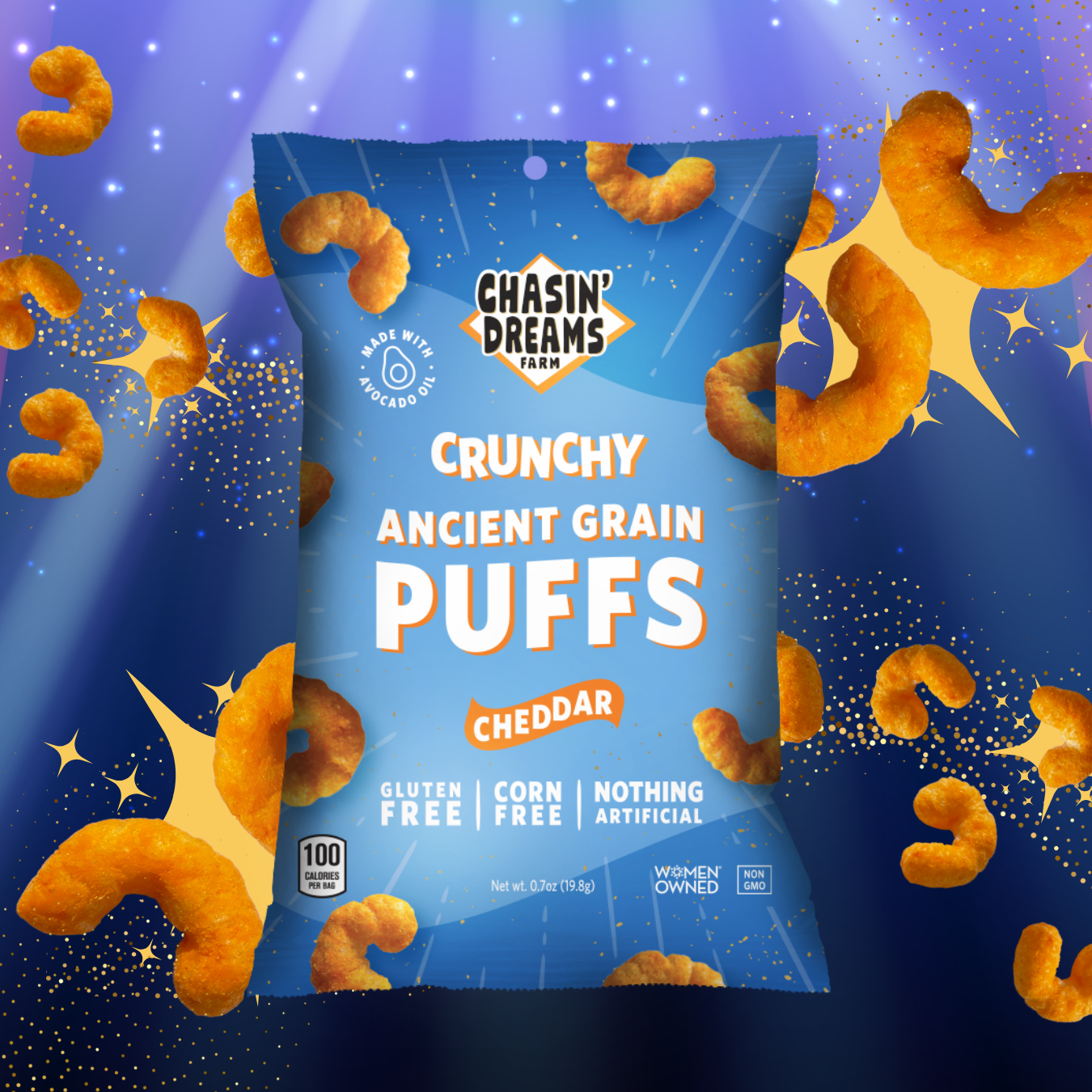 Blue bag of Crunchy Ancient Grain Puffs : Cheddar. Orange puffs on the bag on a blue background with a spotlight.