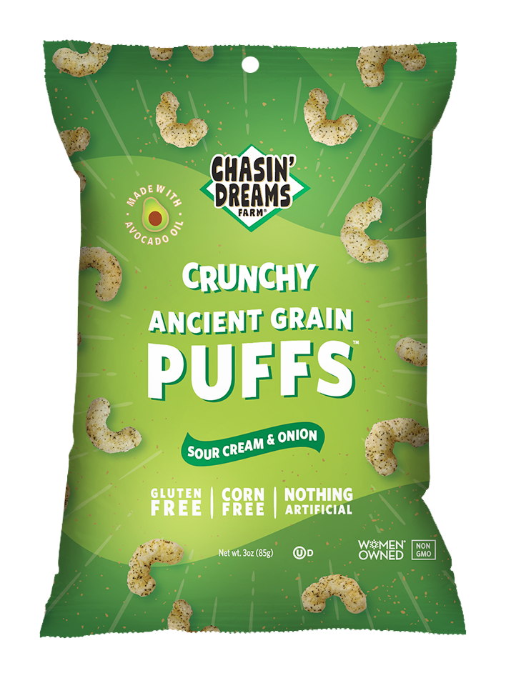 Crunchy Ancient Grain Sour Cream & Onion 3oz Puffs. Green bag with white lines and speckles and beige puffs around the border.
